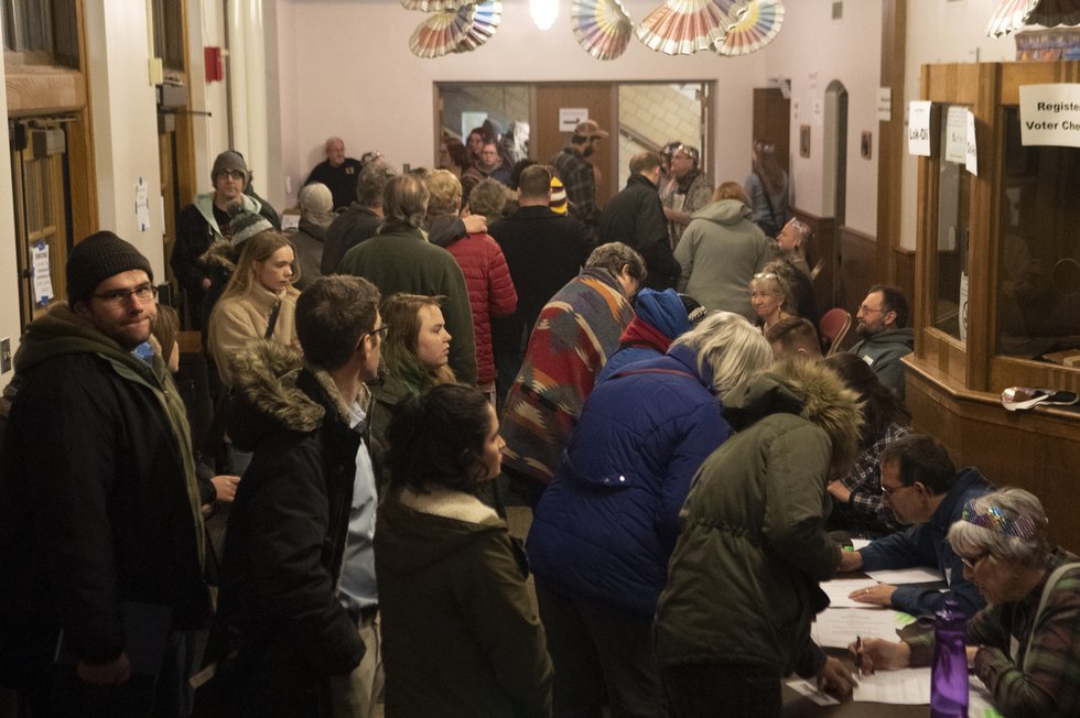 People gather to check-in to vote at the caucus in Ames, Iowa.