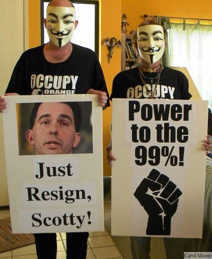 (Vern Nelson and Marselle Sloane of Occupy Orange County prepare to greet Scott Walker – photo by Carol Moore