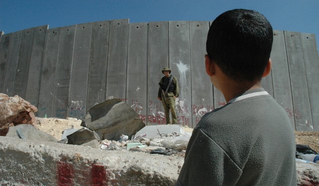 Boy_and_soldier_in_front_of_Israeli_wall.jpg.jpe